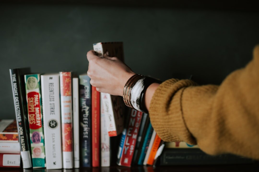 person reading old book in library